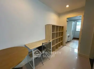 Modern study area with desk, chair, and shelving in a bright apartment