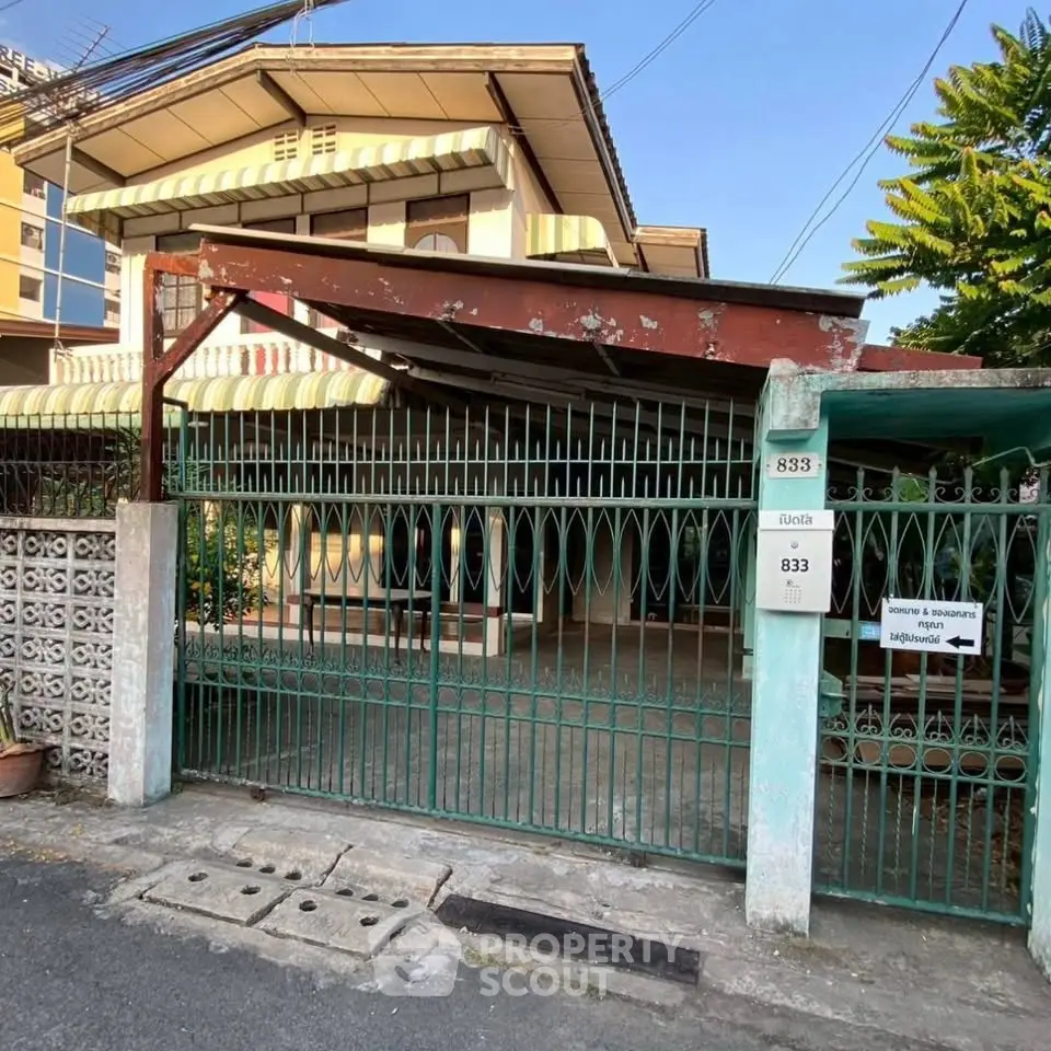 Charming residential property with gated entrance and covered parking in a serene neighborhood.