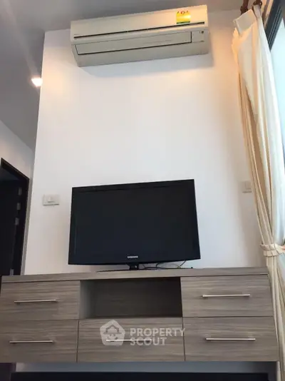 Modern living room with air conditioning and sleek TV setup