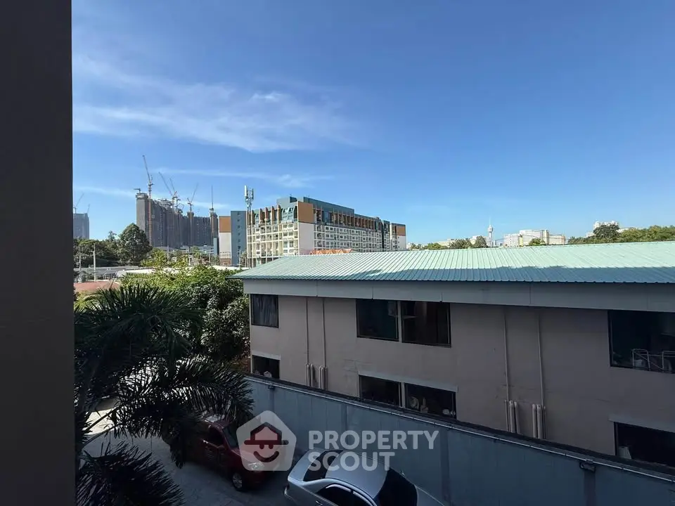 Urban view with modern buildings and clear blue sky, ideal for city living.