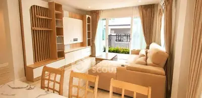 Spacious living room with modern furniture and large windows offering natural light.