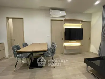 Modern living room with sleek furniture and wall-mounted TV, perfect for contemporary living.