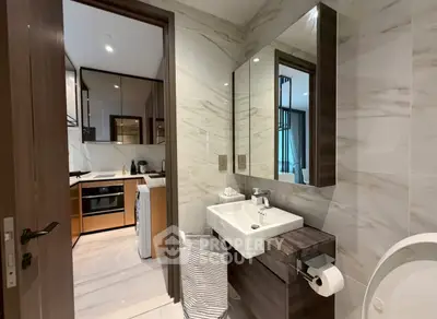 Modern bathroom with sleek design and view into a stylish kitchen