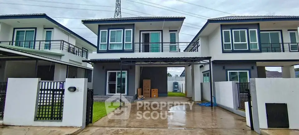 Modern two-story house with spacious driveway and contemporary design.