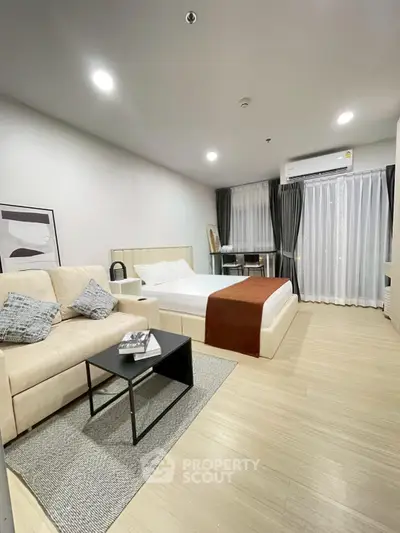 Modern studio apartment with cozy living area and stylish decor