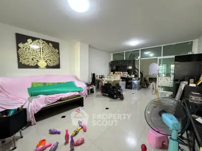 Spacious living room with modern decor and ample natural light, perfect for family gatherings.