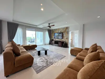 Spacious living room with modern decor and large windows offering natural light.