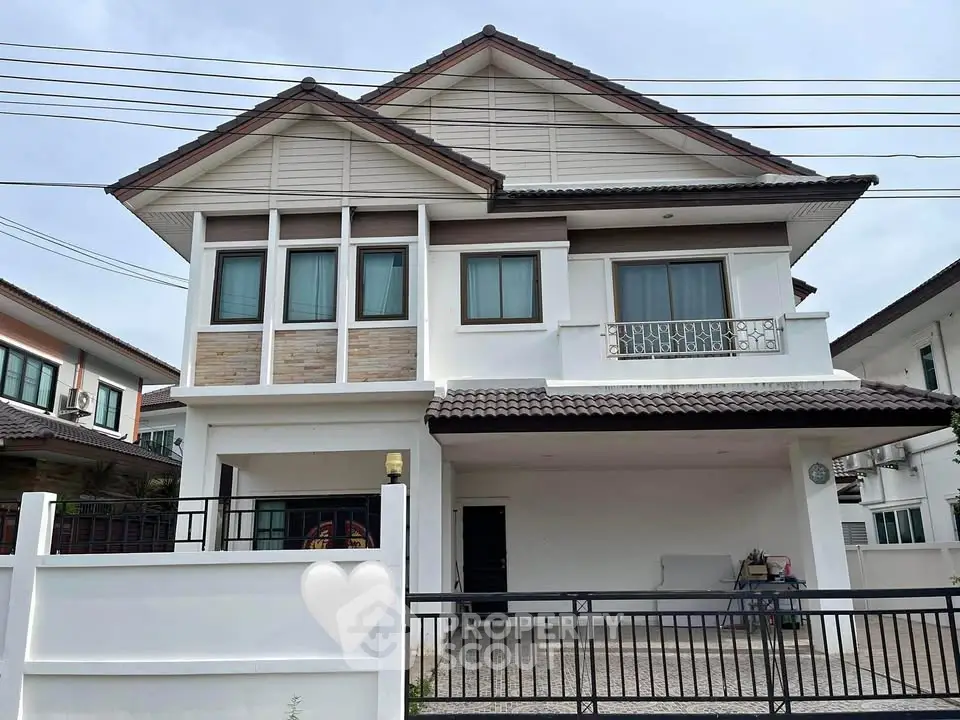 Charming two-story house with modern design and spacious balcony in a serene neighborhood.