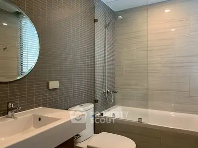Modern bathroom with sleek design featuring a bathtub and stylish fixtures.