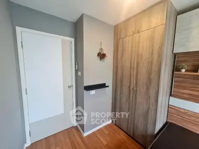 Modern bedroom with wooden flooring and built-in wardrobe