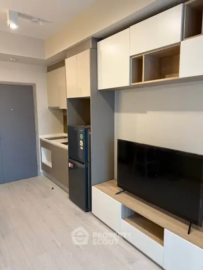Modern apartment interior with sleek kitchen and entertainment area