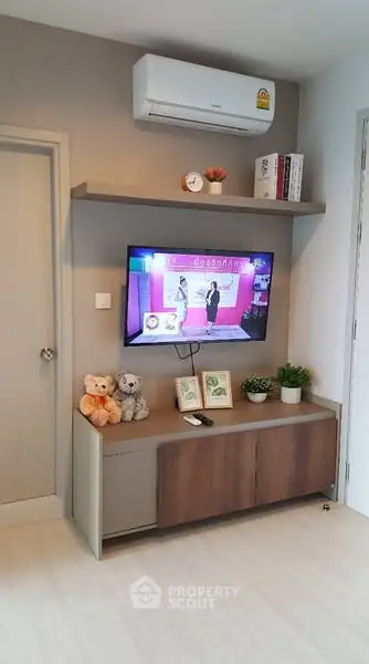 Modern living room with wall-mounted TV and air conditioning unit