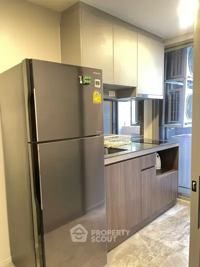 Modern kitchen with stainless steel fridge and sleek cabinetry