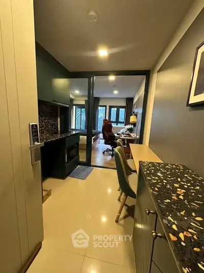 Modern apartment entrance with sleek design and stylish furnishings, leading to a cozy living area.