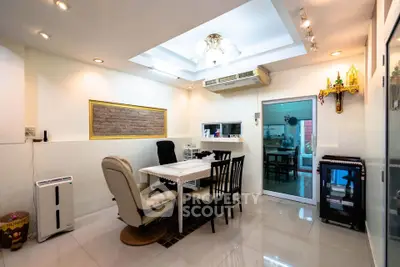 Modern dining area with sleek lighting and air conditioning, featuring a cozy table setup and stylish decor.