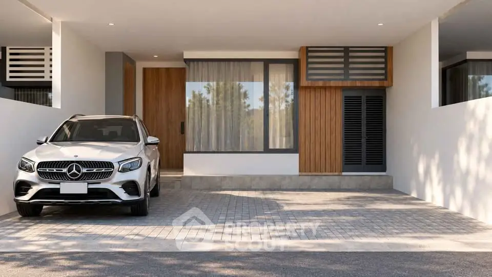 Modern house exterior with carport and luxury vehicle parked in driveway.