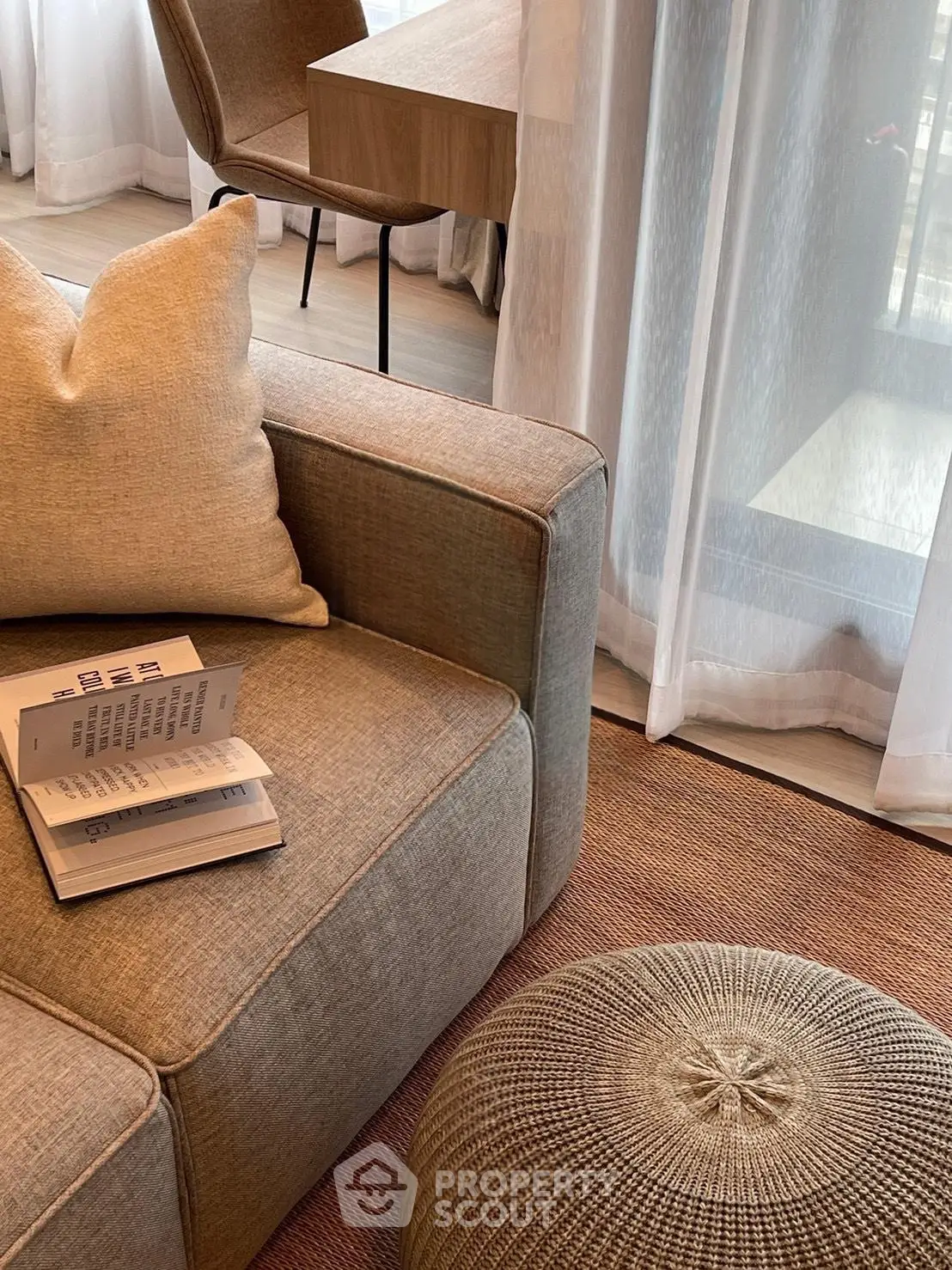 Cozy living room with modern sofa, plush cushions, and elegant decor, perfect for relaxation and comfort.