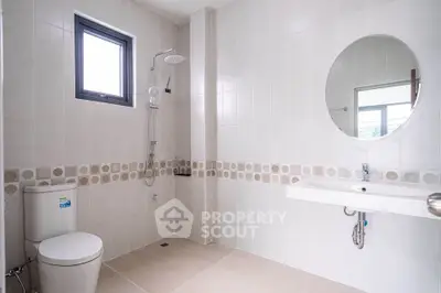 Spacious modern bathroom with elegant tile design and large mirror
