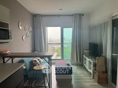 Modern living room with city view, stylish decor, and cozy seating area.