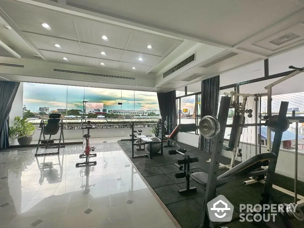 Spacious gym with panoramic city view and modern equipment