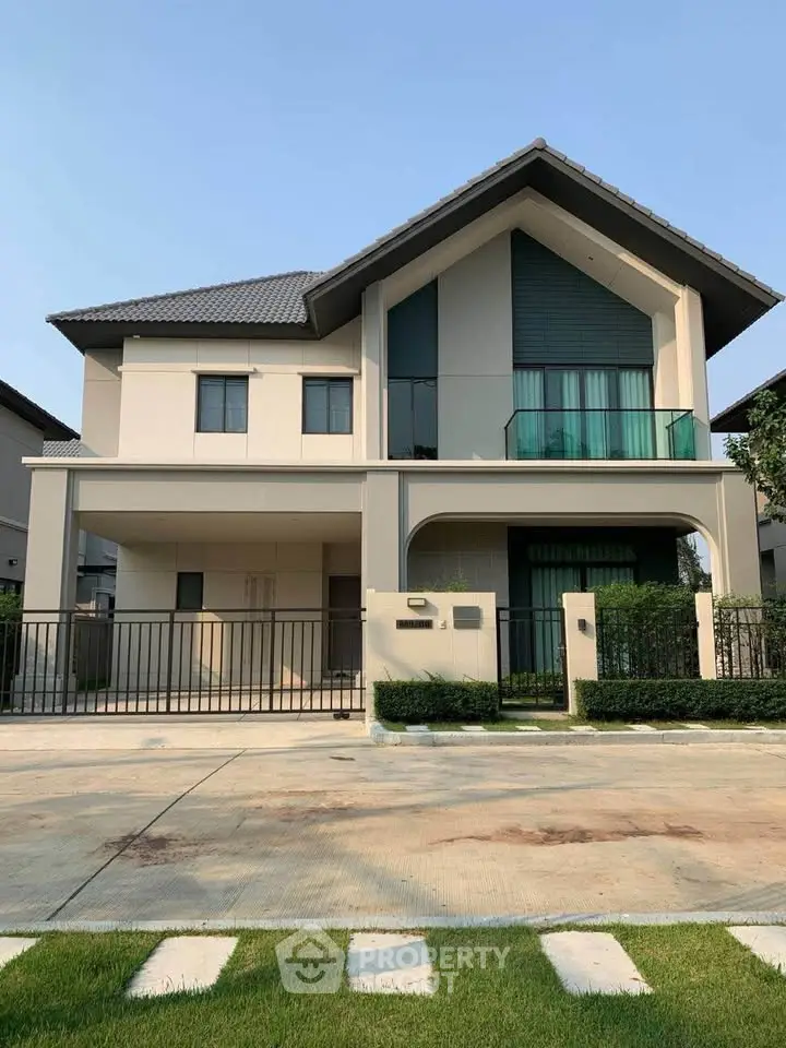 Modern two-story house with sleek design and spacious driveway