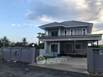 Modern two-story house with spacious driveway and landscaped garden