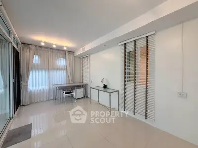 Spacious modern living room with large windows and sleek furnishings