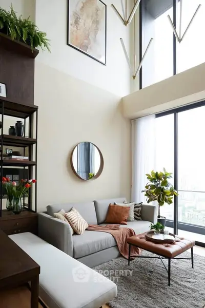 Stylish modern living room with high ceilings and large windows offering a stunning view.