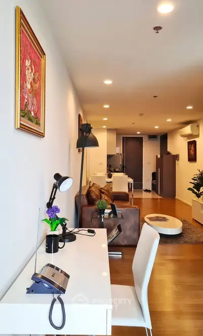 Modern living room with stylish decor and open layout, featuring a cozy seating area and elegant lighting.