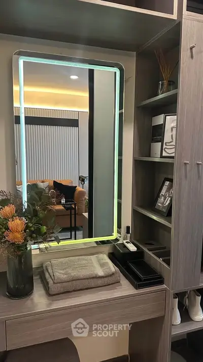 Modern vanity area with illuminated mirror and stylish decor in a contemporary home.