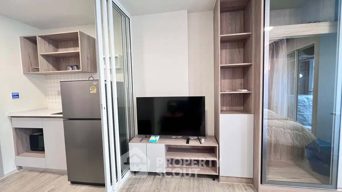 Modern studio apartment with sleek kitchen and cozy living area