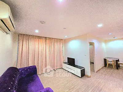 Spacious living room with modern decor and cozy seating area
