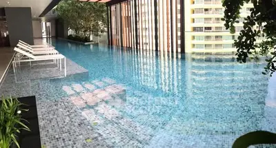Luxurious infinity pool with modern design and serene ambiance in high-end residential building.