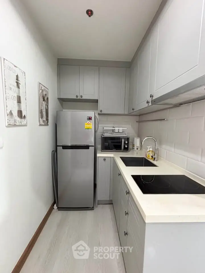 Modern compact kitchen with sleek appliances and stylish cabinetry