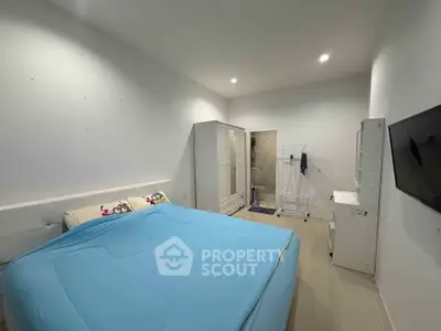 Spacious bedroom with modern furnishings and ample storage, perfect for a cozy retreat.