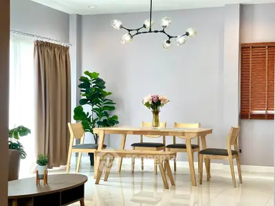 Modern dining area with elegant lighting and stylish wooden furniture