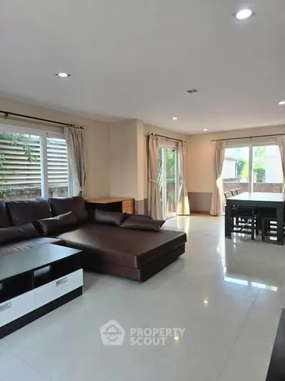Spacious living room with modern furniture and large windows for natural light