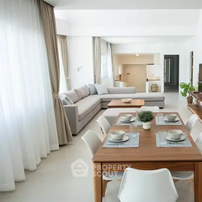 Spacious modern living and dining area with elegant decor and natural light.