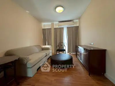 Cozy living room with elegant furniture and natural light, perfect for relaxation.