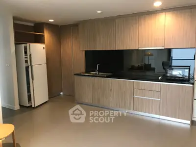 Modern kitchen with sleek wooden cabinets and stainless steel appliances