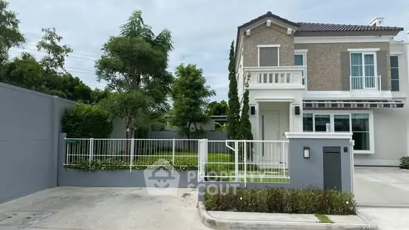 Charming two-story house with lush garden and modern exterior design in a serene neighborhood.