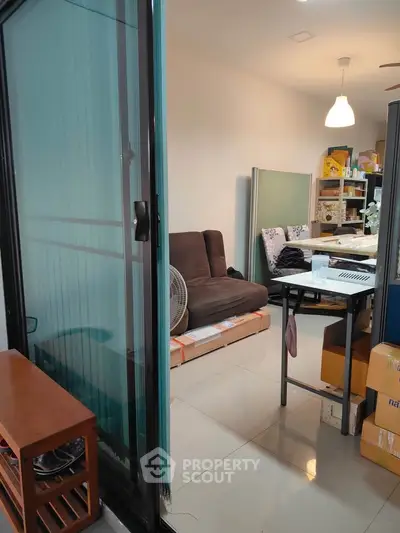 Cozy living space with sliding glass door and modern furnishings, ideal for urban living.