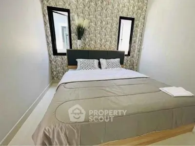 Cozy bedroom with stylish wallpaper and modern decor, perfect for relaxation.