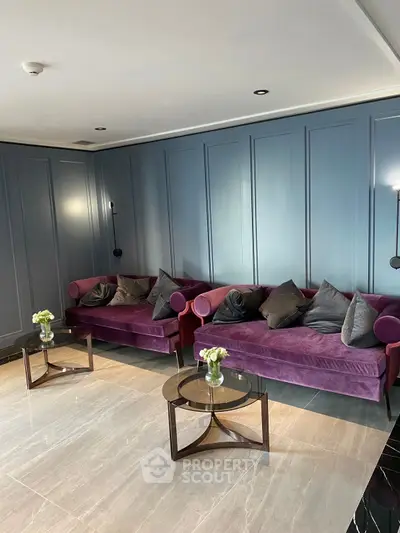 Elegant living room with plush purple sofas and modern decor