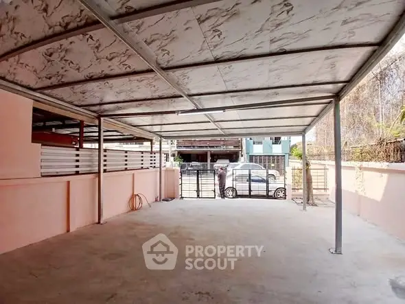 Spacious covered parking area with modern design and ample space for vehicles.