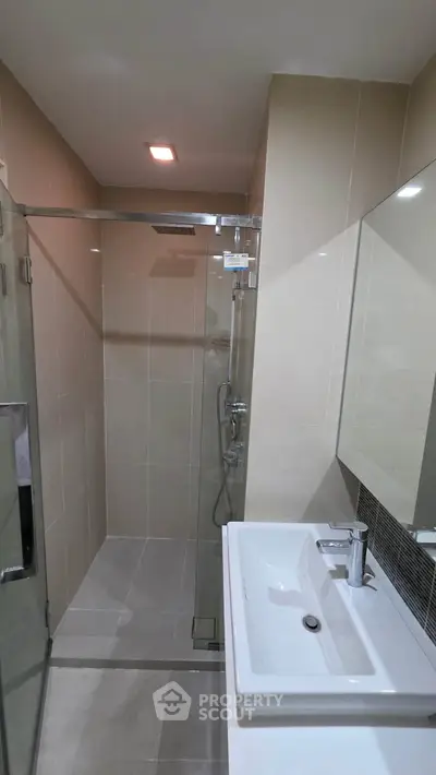 Modern bathroom with glass shower and sleek sink design