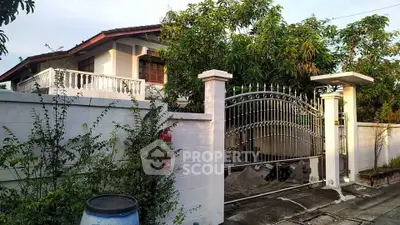 Charming suburban home with lush garden and secure gated entrance, perfect for family living.