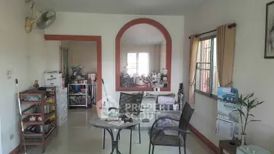 Cozy living room with dining area and natural light, featuring modern furniture and decor.