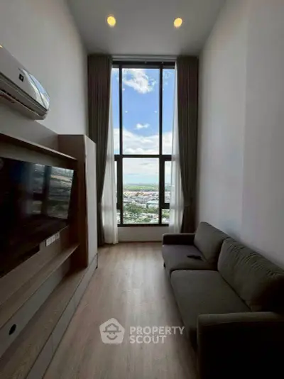 Modern living room with floor-to-ceiling window and stunning city view