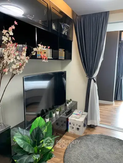 Modern living room with sleek black entertainment unit and stylish decor